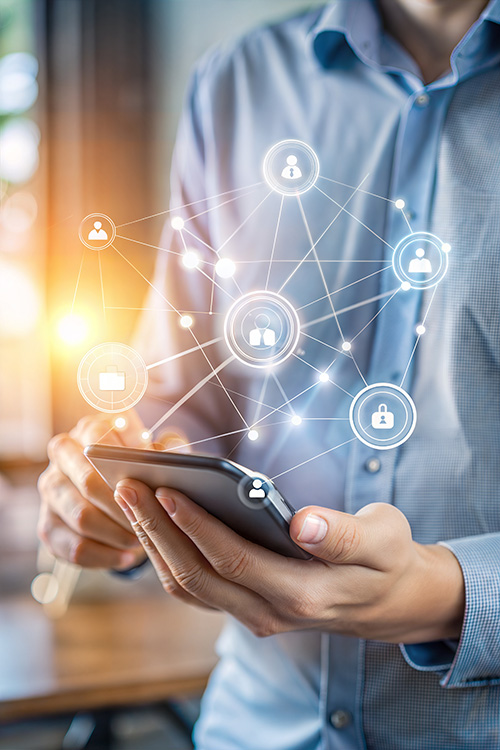 Smartphone held in hands with a glowing network of interconnected icons (people, lock, folders) representing digital connectivity and security of data.